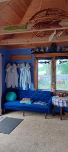 a blue couch in a room with two windows at Blū House in Williamsburg