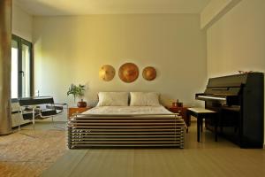 a bedroom with a bed and a piano and planets on the wall at Kallimarmaro Residence in Athens +24 photos