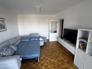 a room with a bed and a couch and a television at Apartment 7 in Izola