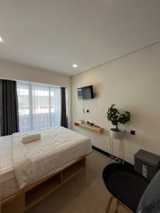 a bedroom with a large bed and a window at Alzeto Coliving in Legian +27 photos