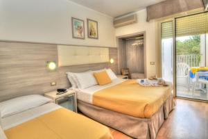 Postel nebo postele na pokoji v ubytování Hotel Colorado
