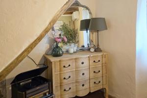 a dresser with a mirror on top of it at Le Allegre Comari di Nesso, casa e benessere in Nesso