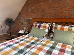 a bedroom with a bed and a brick wall at Ferienwohnung Domaene Kermen in Kermen