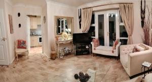 a living room with two couches and a tv at Canalside Chic Your London Escape Starts Here WIFI and Airport Transfers in Hemel Hempstead