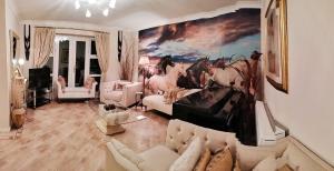 a living room with a painting of horses on the wall at Canalside Chic Your London Escape Starts Here WIFI and Airport Transfers in Hemel Hempstead