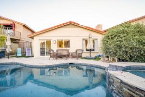 a swimming pool in front of a house at Desert View Home Pool & Hot Tub in Phoenix