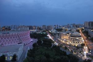 a view of a city at night with lights at Grand Hotel Europe in Baku