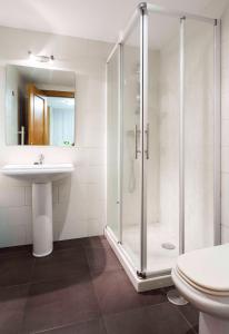 a bathroom with a shower and a sink at Apartamentos Cotiello in Llanes +26 photos