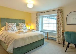 a bedroom with a large bed and a window at Skelwith Fold Cottage No.3 in Elterwater