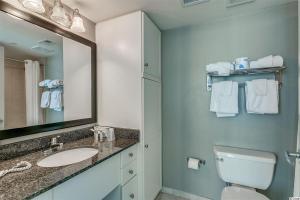 a bathroom with a sink and a toilet and a mirror at Spacious 2 Bedroom Oceanview Condo! 9th Floor Views! Oceans One 908 in Myrtle Beach +33 photos