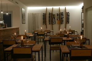 a restaurant with wooden tables and chairs and wine racks at OrtoPì Country Canapa House in Porto Recanati