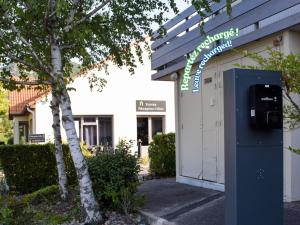 a parking meter in front of a building at Campanile Millau in Millau