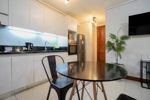 a kitchen with a table and two chairs in a kitchen at Delightful Studio Apartment in Las Condes in Santiago