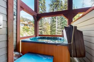 a jacuzzi tub on the outside of a house at Snowbanks 2 in Big White