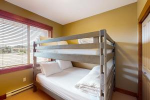 a bunk bed in a room with yellow walls at Snowbanks 2 in Big White +13 photos