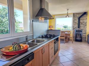 a kitchen with a bowl of fruit on the counter at Holiday Home de la Plage by Interhome in Pleubian +34 photos