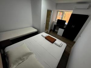 a small room with a bed and a desk with a laptop at Casa Hax Mangalia in Mangalia