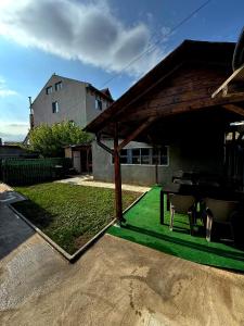 a patio with a table and chairs in a house at Casa Hax Mangalia in Mangalia