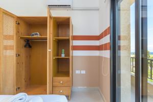 a room with a bed and a glass wall at Glow - Stylish Apartments & Rooftops in Batroun  +271 photos