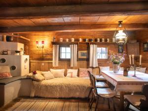 a bedroom with a bed and a table in a room at Chalet Troadkasten by Interhome in Neuhofen im Innkreis