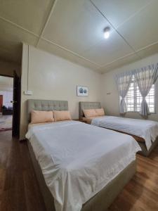 Postel nebo postele na pokoji v ubytování NKL Homestay Kundasang
