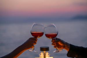 two people holding up two glasses of wine at Lov Faralya Adults Only in Faralya