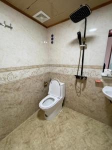 un baño con inodoro y lavabo en Homey Hotel, en Lào Cai 2 fotos más