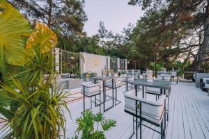 a row of tables and chairs on a patio at Lov Faralya Adults Only in Faralya +37 photos