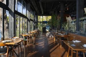 a row of tables in a restaurant with windows at Lov Faralya Adults Only in Faralya