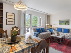 a living room with a table and a couch at Apartment Allod Park Haus C 501 by Interhome in Davos