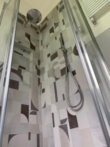 a shower in a bathroom with a tile floor at A Casa di Vanna in Montese +43 photos