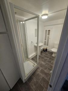 a bathroom with a shower and a toilet and a sink at The Bulls Head Hotel in Youlgreave