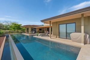 a swimming pool in the backyard of a house at Oceanview Villa in Mar Vista, Infinity Pool in Playa Flamingo +18 photos