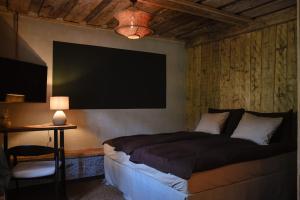 a bedroom with a bed and a flat screen tv at Boutique Hotel ALTENBURG in Talsi