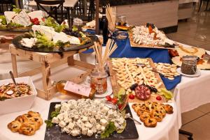 a table with many different types of food on it at Topaz Hotel in St Paul's Bay