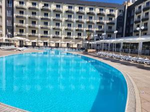 a large swimming pool in front of a hotel at Topaz Hotel in St Paul's Bay
