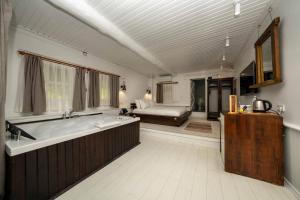 a large bathroom with a tub and a bed at Lov Faralya Adults Only in Faralya