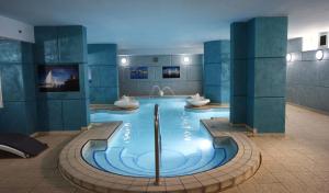 a large swimming pool with two sinks in a building at Topaz Hotel in St Paul's Bay