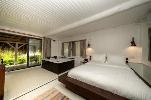 a bedroom with a bed and a bath tub at Lov Faralya Adults Only in Faralya