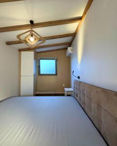 a room with a large bed in a room at Cosy Paradise in Palouki