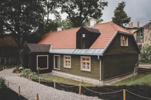 a small black house with a red roof at Boutique Hotel ALTENBURG in Talsi