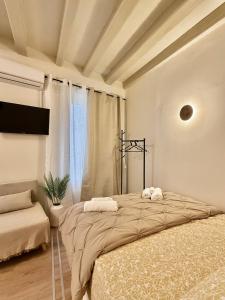 a bedroom with a large bed with two towels on it at Lumière Carmela in Corfu