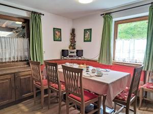a dining room with a table and chairs at Holiday Home Farm Eben by Interhome in Ginzling