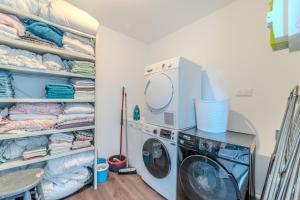 a laundry room with a washer and dryer at Hortensia Roanne centre-ville - Parking & Clim in Roanne