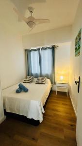 a bedroom with a bed with a ceiling fan at Mariola Vista Mar in Ifach