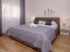 a bedroom with a large bed with two pillows at Apartments Villa Senija in Prizba