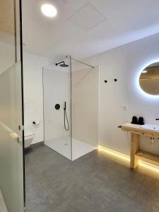 a glass shower in a bathroom with a sink at Maison Laida in Ibarrangelu +52 photos