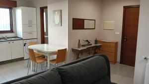 a living room with a couch and a table and a kitchen at Villa Ruperta in A Guarda