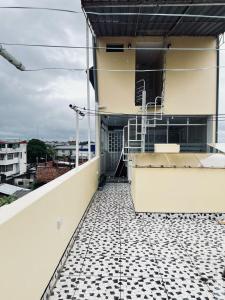 a balcony of a building with a tiled floor at Departamento Céntrico in Pucallpa