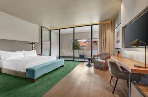 a hotel room with a bed and a desk at Hilton Porto Gaia in Vila Nova de Gaia +99 photos